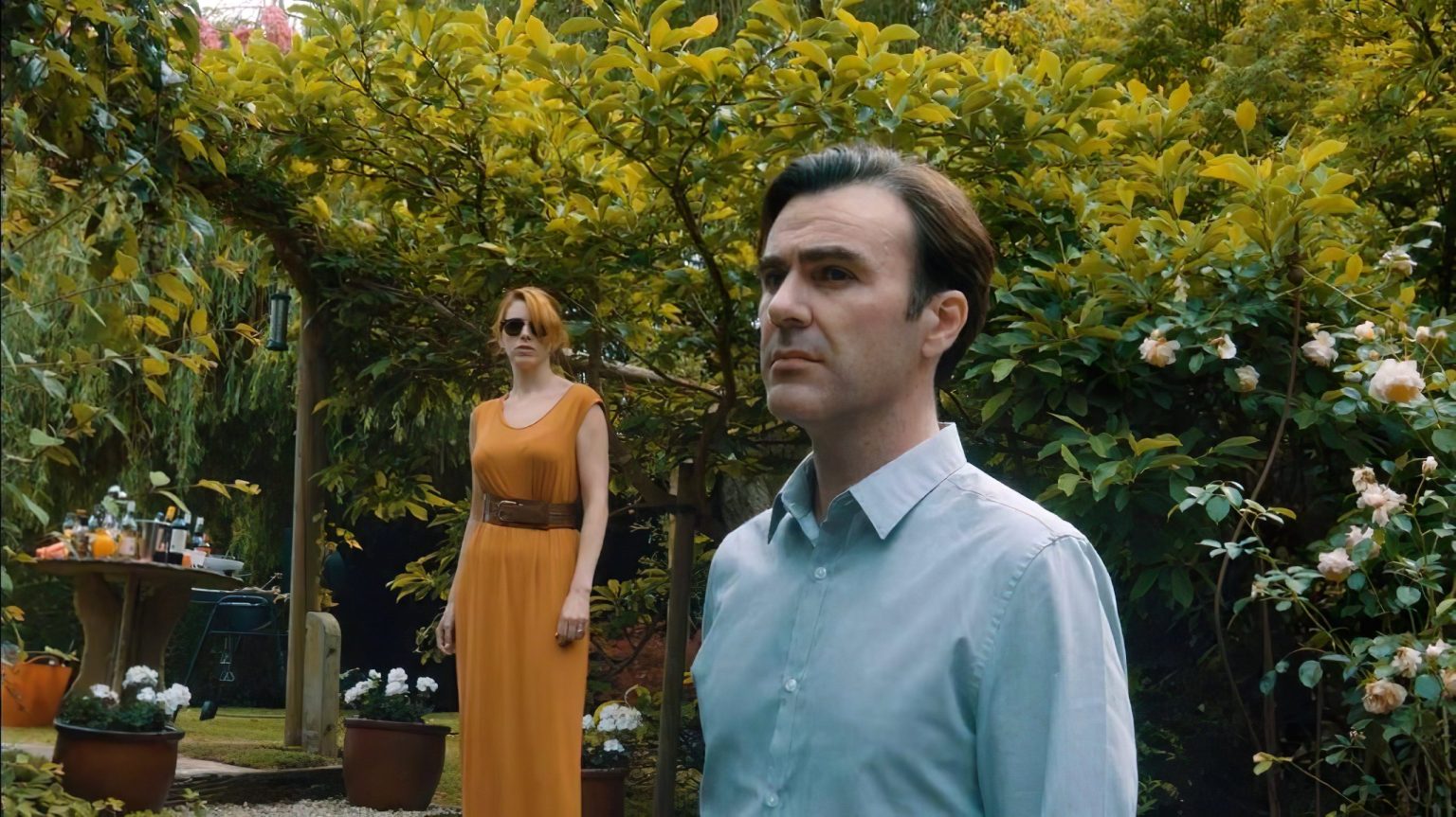 Two characters in a garden from the short thriller film A Friend in Need