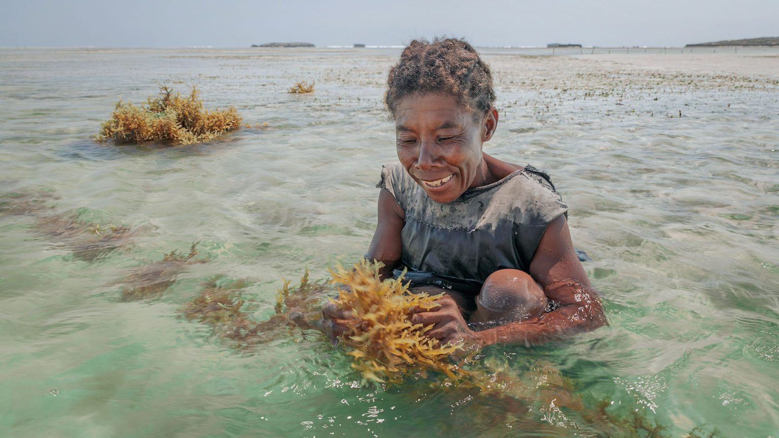 Madame Kokoly standing in the sea, from Blue Ventures documentary film Kokoly