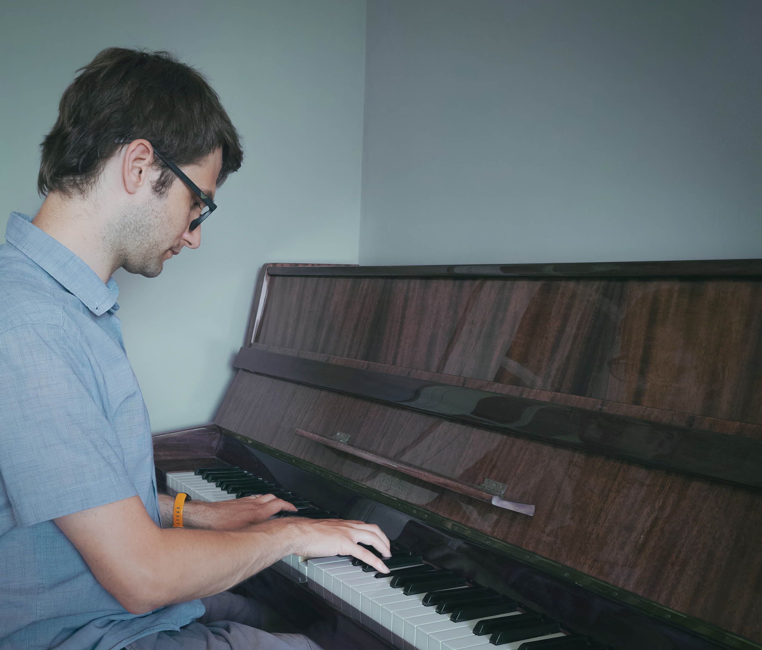 Yorkshire-based film composer Robert Drane playing an upright piano
