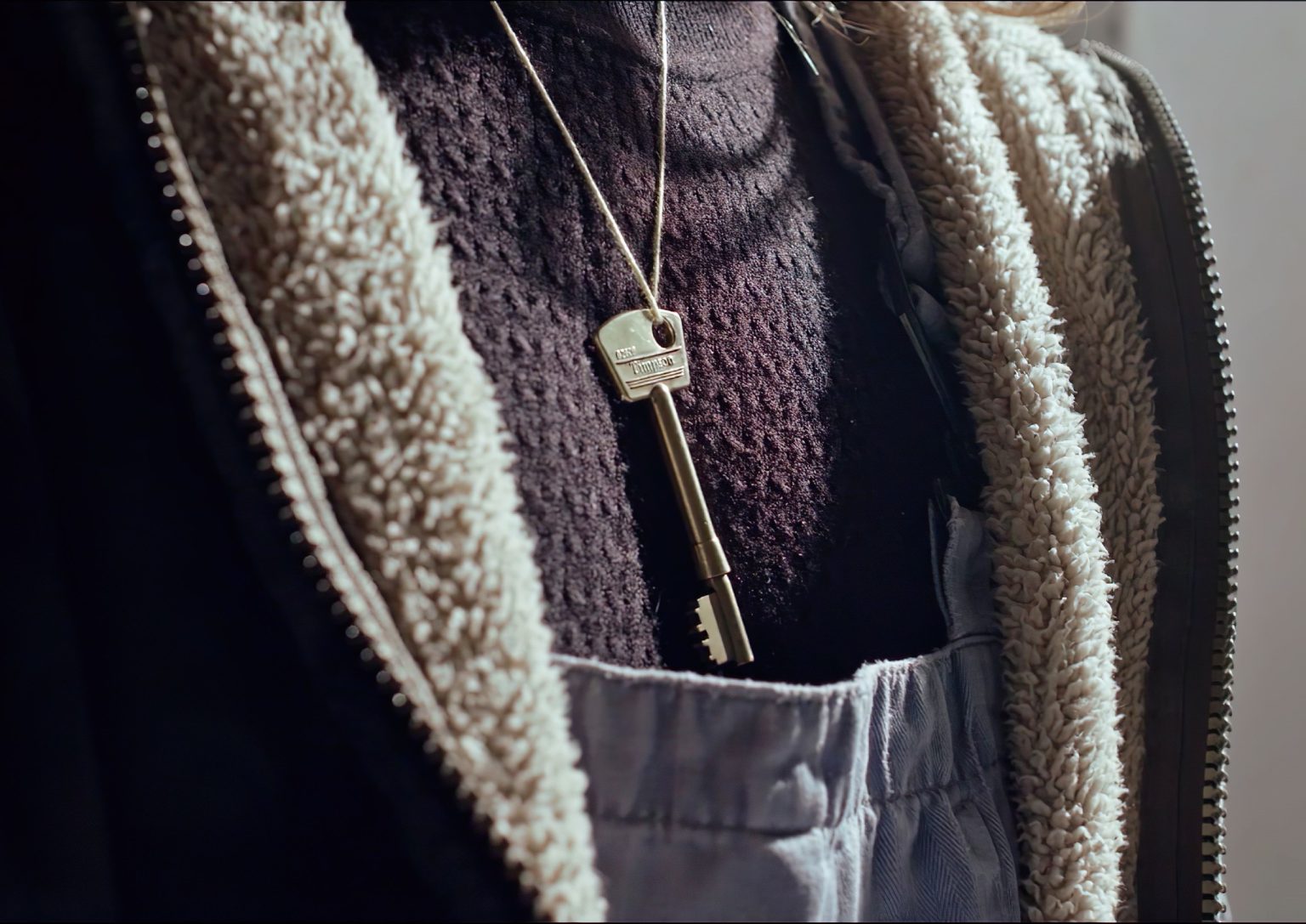 A key on a chain around a woman's neck from short film Sad Pretty Pictures